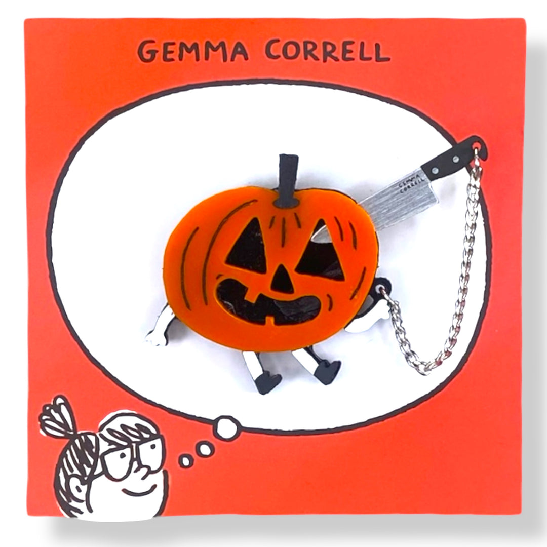 Gemma Correll Halloween-themed brooch with jack-o-lantern pumpkin and knife on a red branded card.