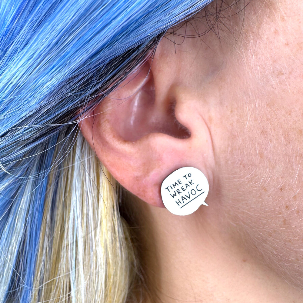Close up of 'Time to Wreak' havoc speech bubble earring on a model's ear.