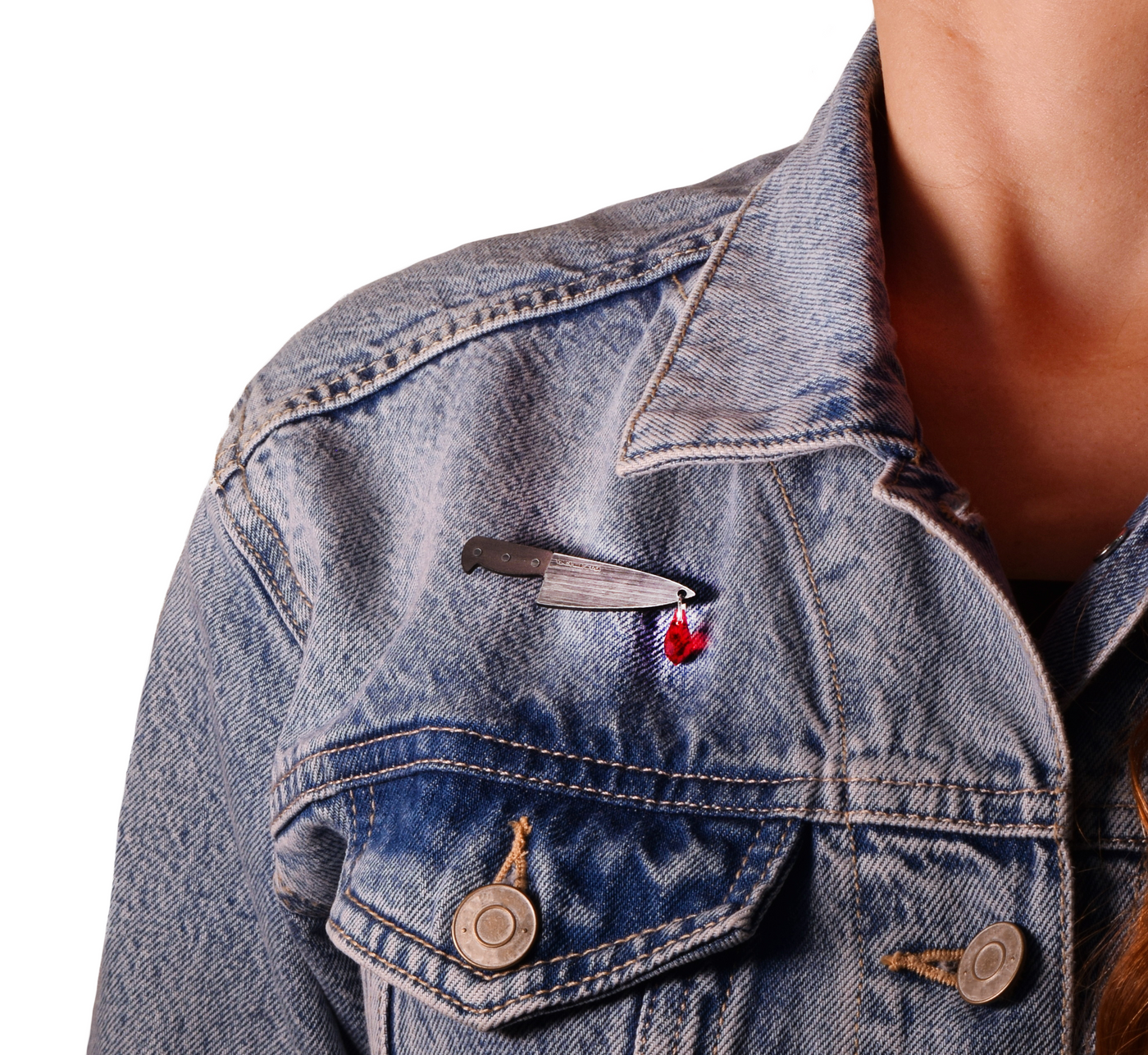 Chef's knife pendant with Austrian crystal blood drop pinned to a jean jacket and worn by a model.