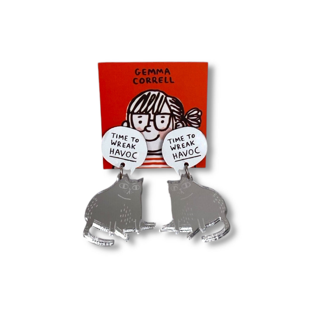 Pair of earrings with 'Time to wreak havoc' text on a white speech bubble attached to a mirror silver plastic cat on a red card branded with Gemma Correll's logo.