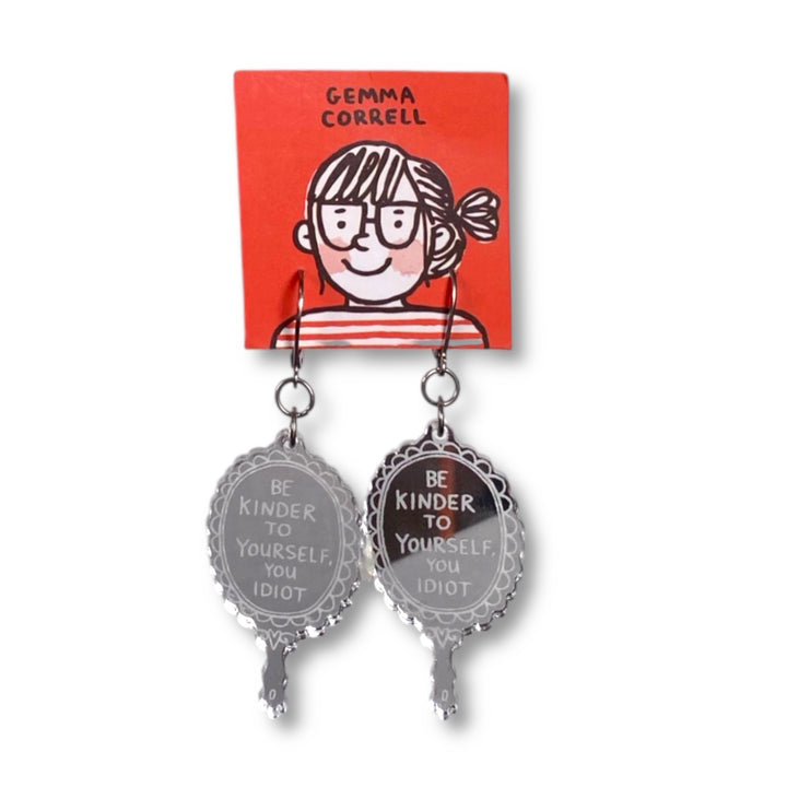 Gemma Correll hand mirror dangle earrings with the phrase, 'Be Kinder to Yourself, You Idiot.'