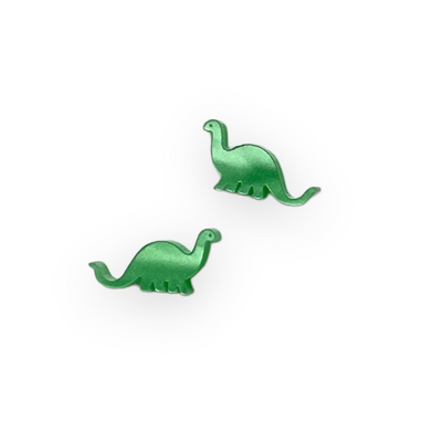 Pearl green plastic Brontosaurus dinosaur earrings sit against a white background.