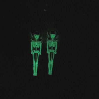 Video showcasing a '60s style doll's articulated skeleton earring that glows-in-the-dark. 