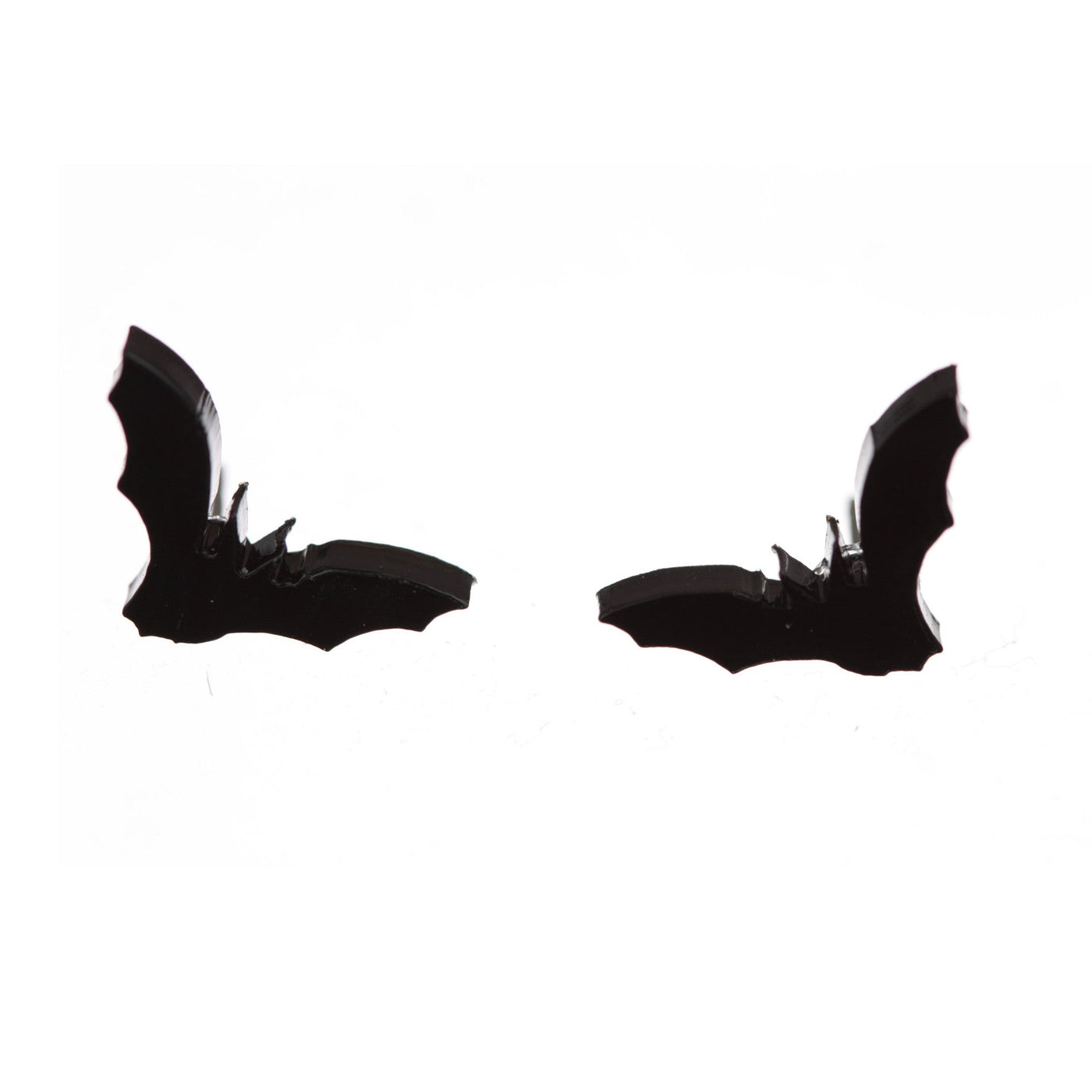 Shiny black vampire bat earrings on a white background.