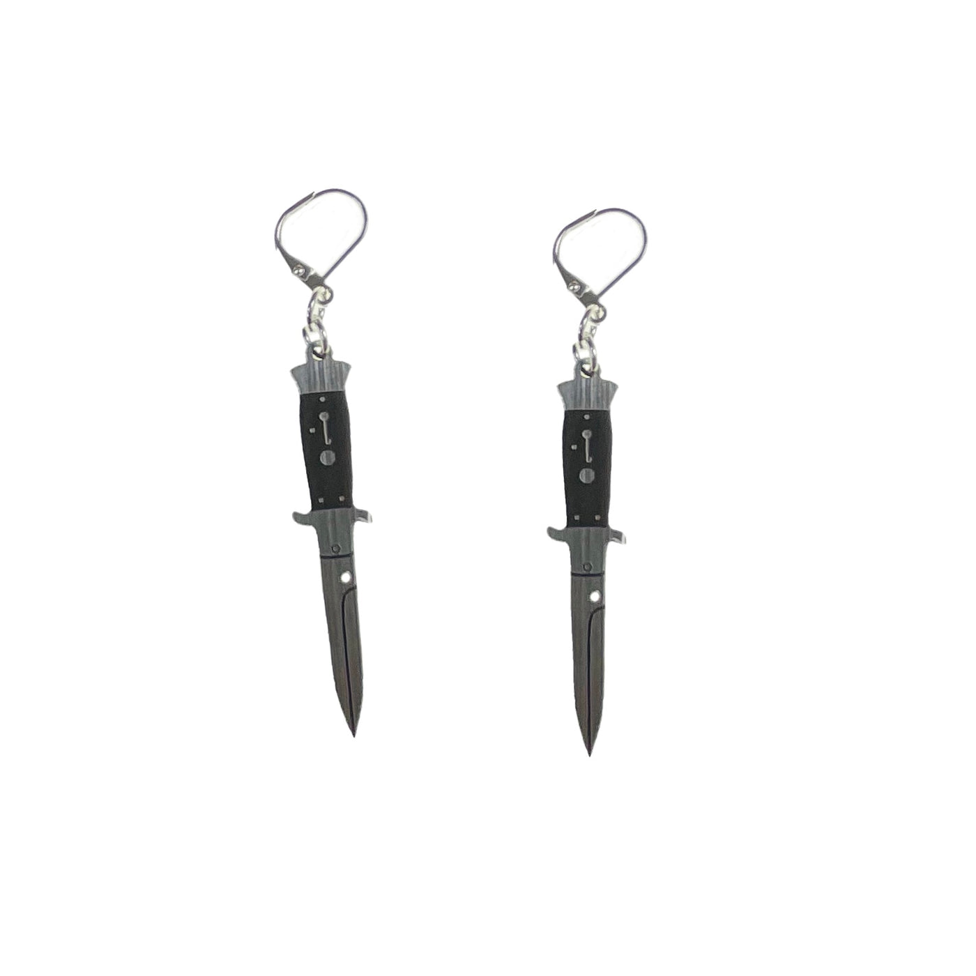 A pair of silver tone switchblade knife dangle earrings sit on a white background. 