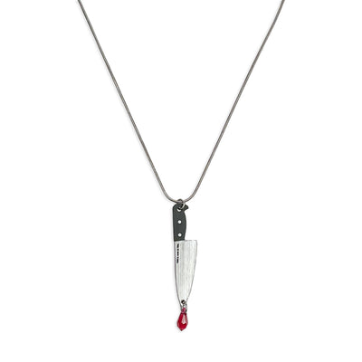 Sterling silver necklace with plastic knife charm and Austrian crystal on a white background.