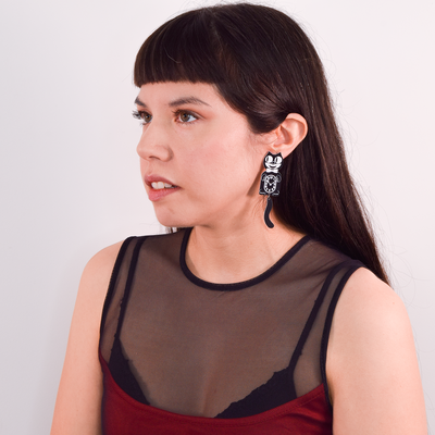 Extra large, officially licensed, black and white Kit-Cat Klock earrings on a alternatively styled model.