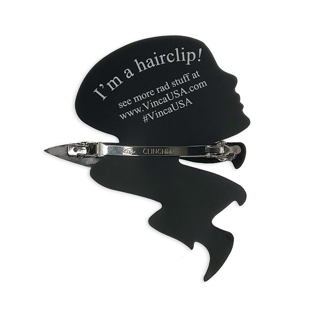 The back of our 3" Chef's Knife hair clip is a French barrette-style clip clasped onto a Vinca packaging card and on a white background.