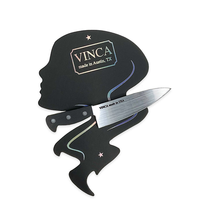 Our 3" plastic Chef's Knife Hair clip is clipped onto a Vinca branded card and photographed on a white background.