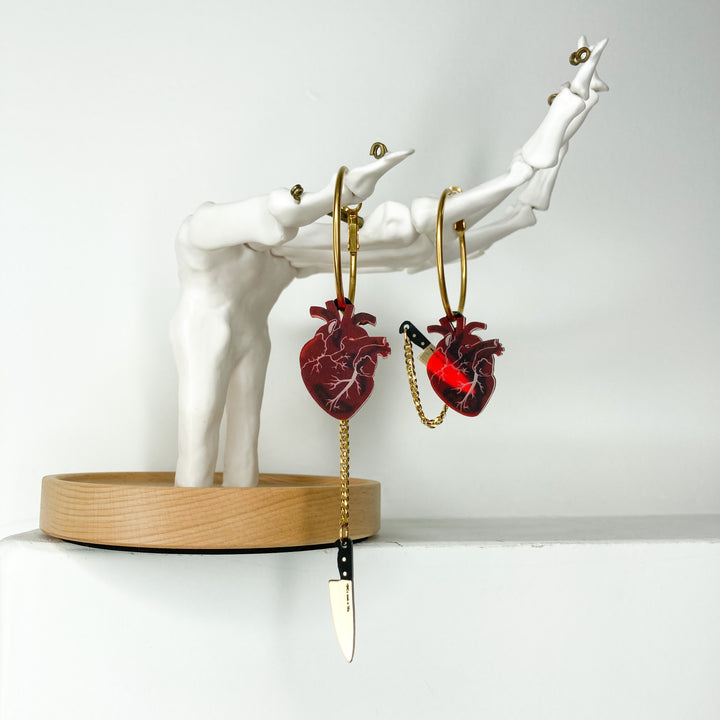 Chopped Heart Hoop Earrings with frosted red anatomical heart charms on gold plated surgical steel hoops.