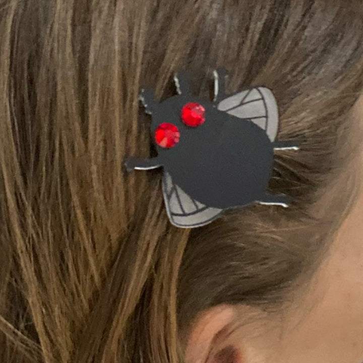 mothman hair clip in brown hair