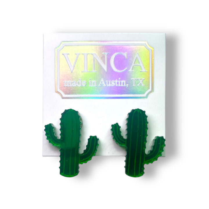 Saguaro succulent cactus earrings on a white card set against a 
white background