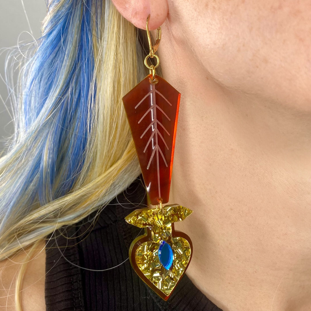 Close-up of a person wearing Vinca's Aaliyah-inspired Statement Earring Society piece.
