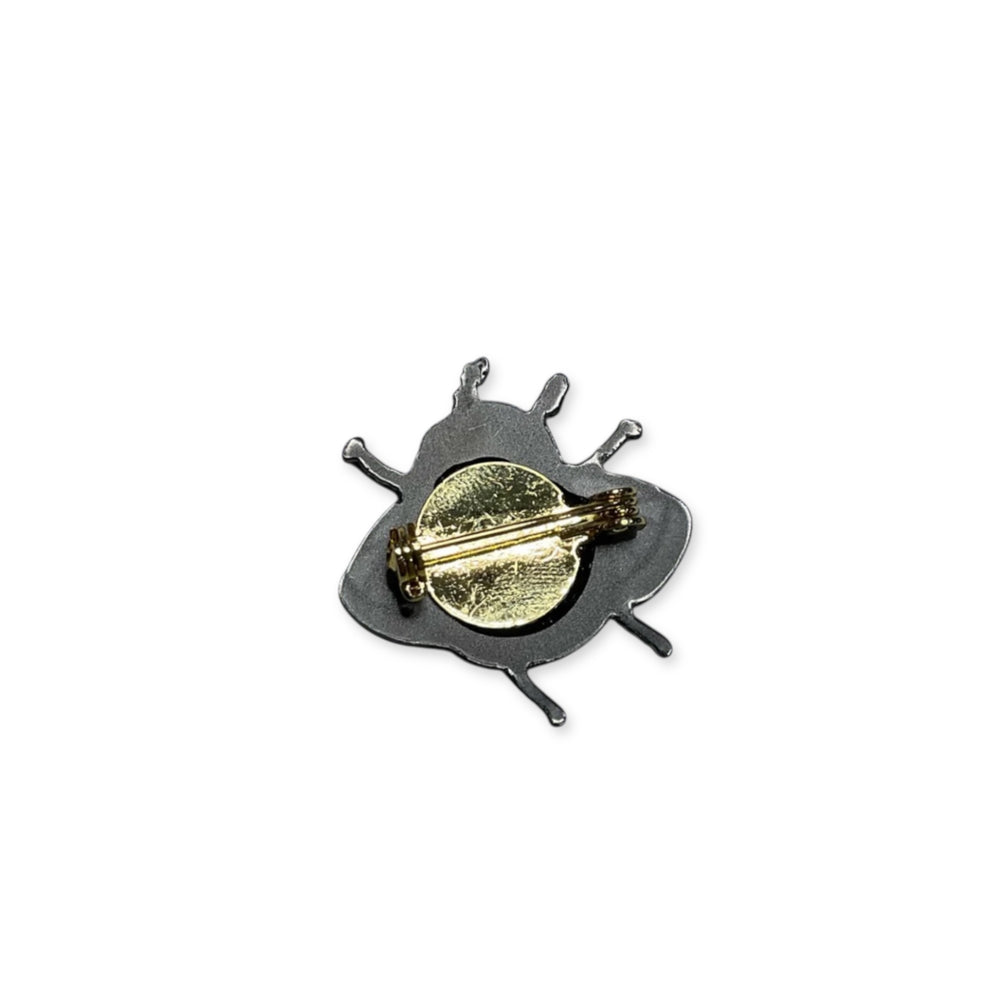 The back of Sarah's Scribbles Mothman brooch on a white background. 
