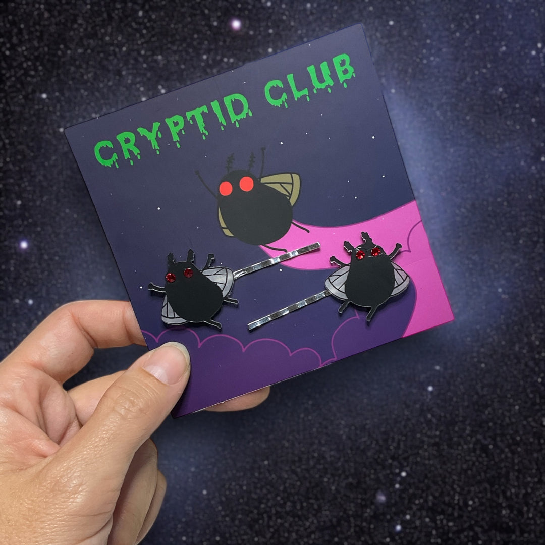 sarah's scribbles cryptid club mothman bobby pins held in hand on a card