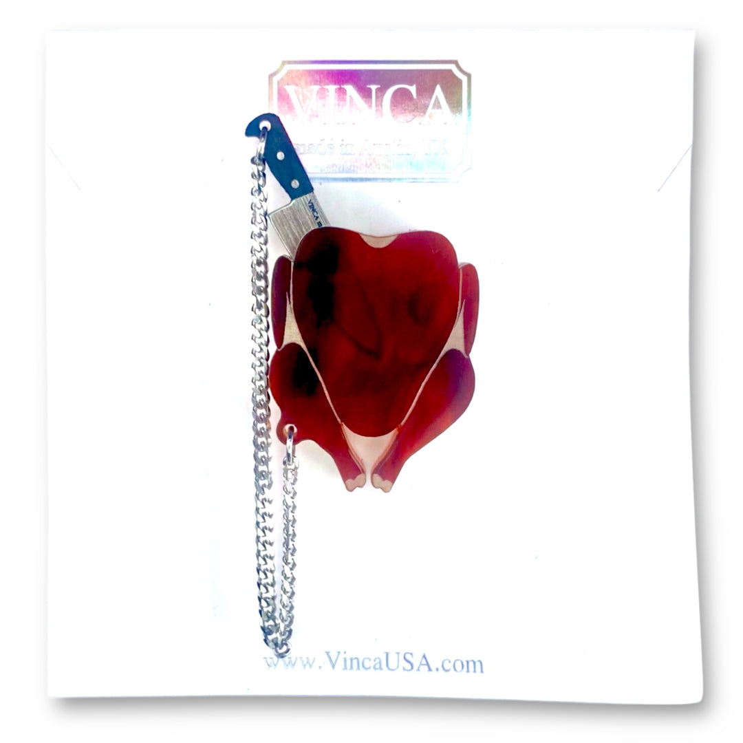 Handmade roasted turkey, chicken, poultry brooch pin with removable chef's knife on a white branded Vinca card on a solid white background.