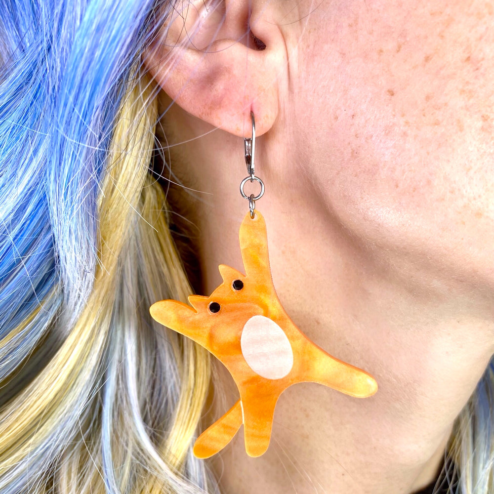 One side of our Handmade Sarah's Scribbles Orange and Black Cat dangle earrings. 