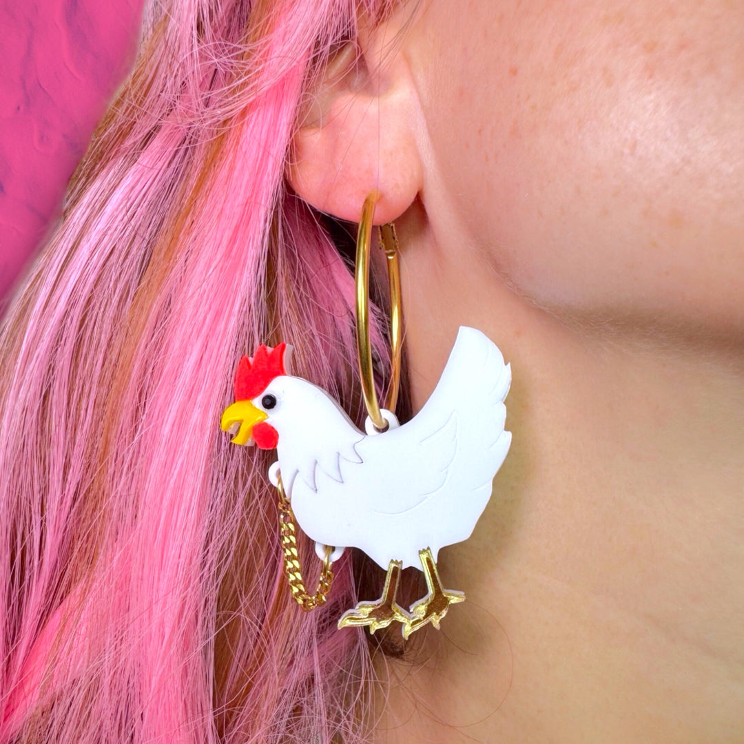 handmade chicken earrings with removeable head as worn by a model with pink hair