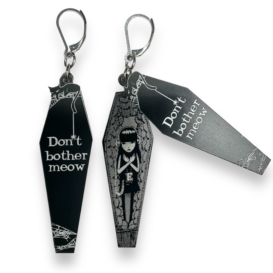 Officially licensed Emily the Strange "Don't Bother Meow" black stainless steel hook earrings set against a white background.