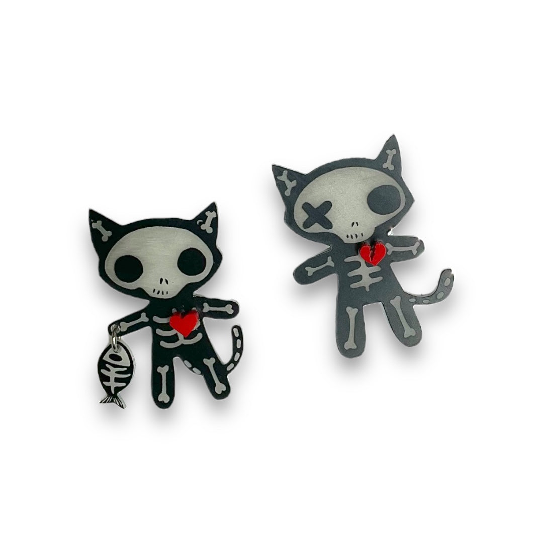 Officially licensed Emily the Strange goth cat skeleton earrings on a white background.