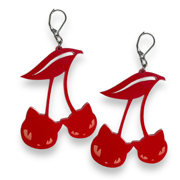 Our officially licensed Emily the Strange goth red cat cherry hook dangle earrings are set against a white background.