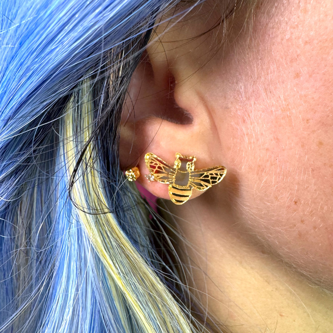 handmade quirky mirror gold bee earring on model with colorful hair