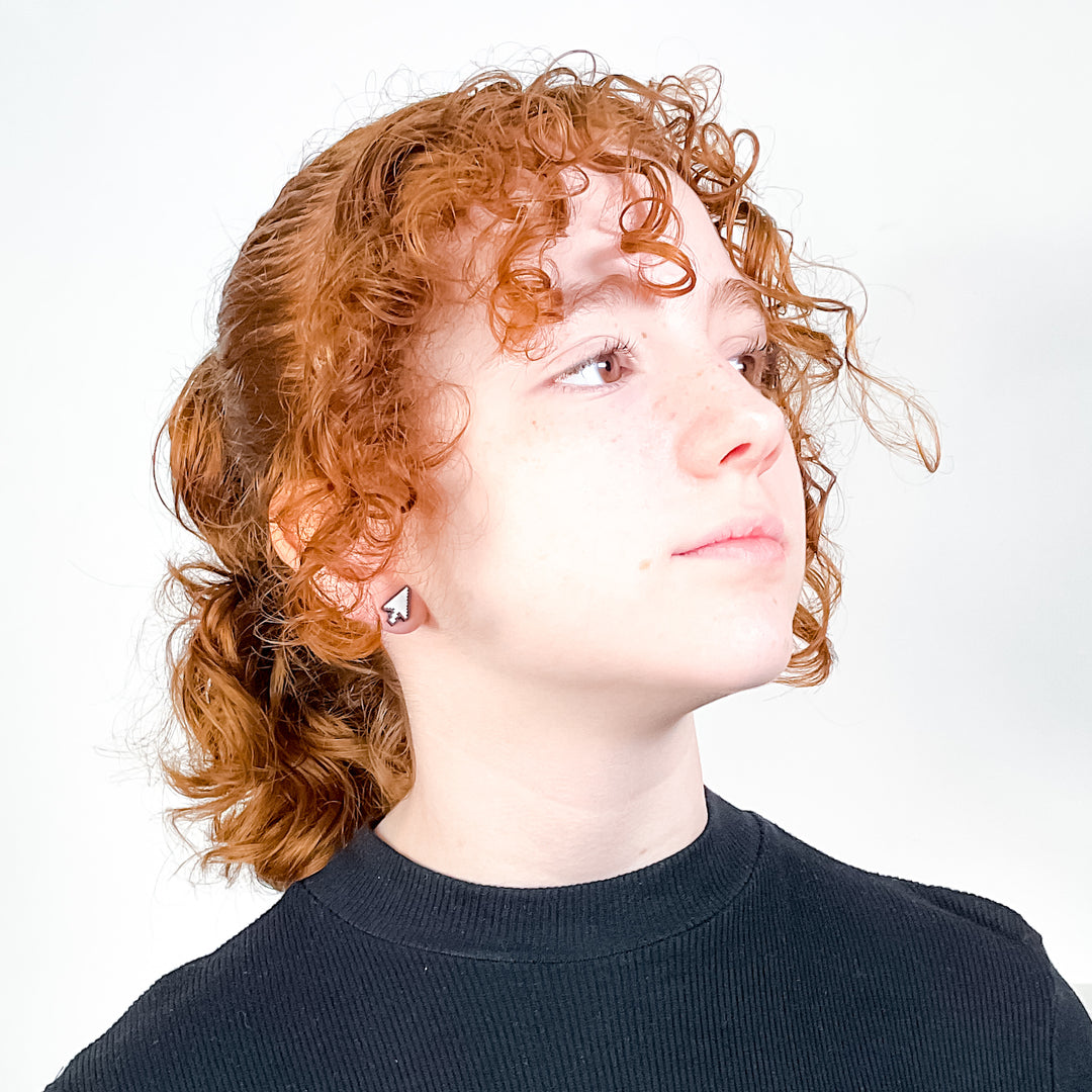 Model wearing handmade cursor arrow earrings