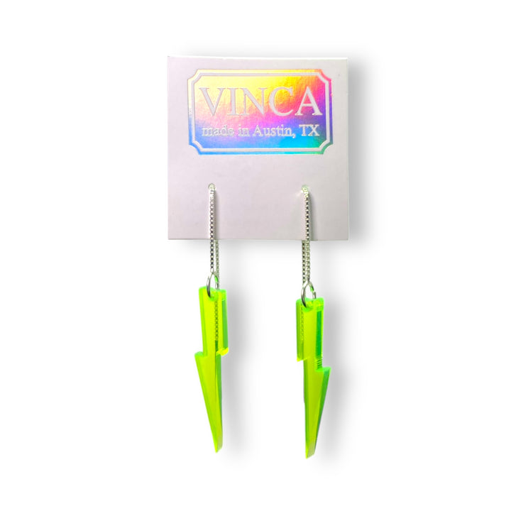 neon green lightning bolt ear threaders on a white card against a white background.