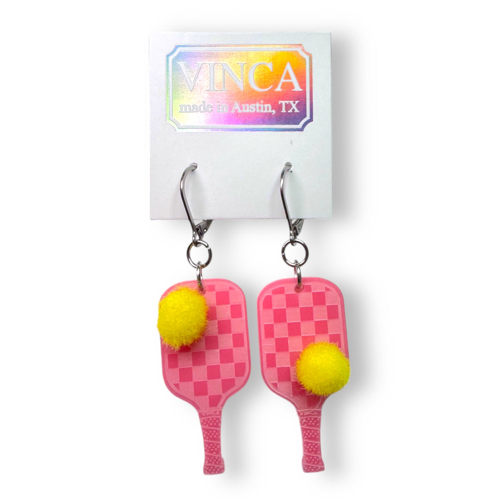 Pink pickleball paddles with checkerboard pattern and yellow pickle ball