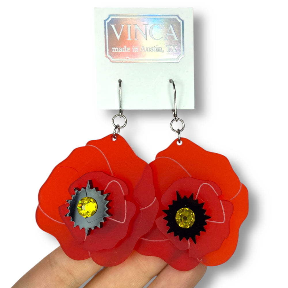 Bright red wildflower Poppy Dangle Earrings on a white branded Vinca card. 