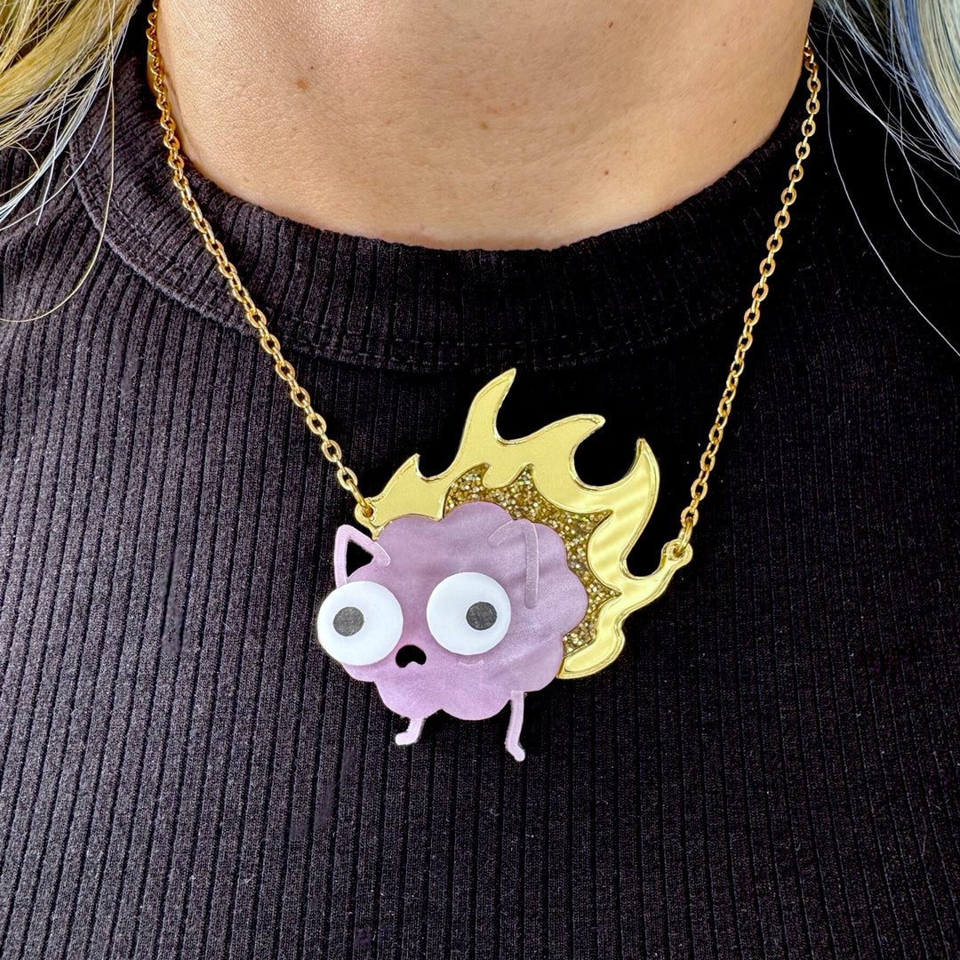Sarah's Scribbles brain on fire necklace worn by a person wearing a black ribbed shirt.