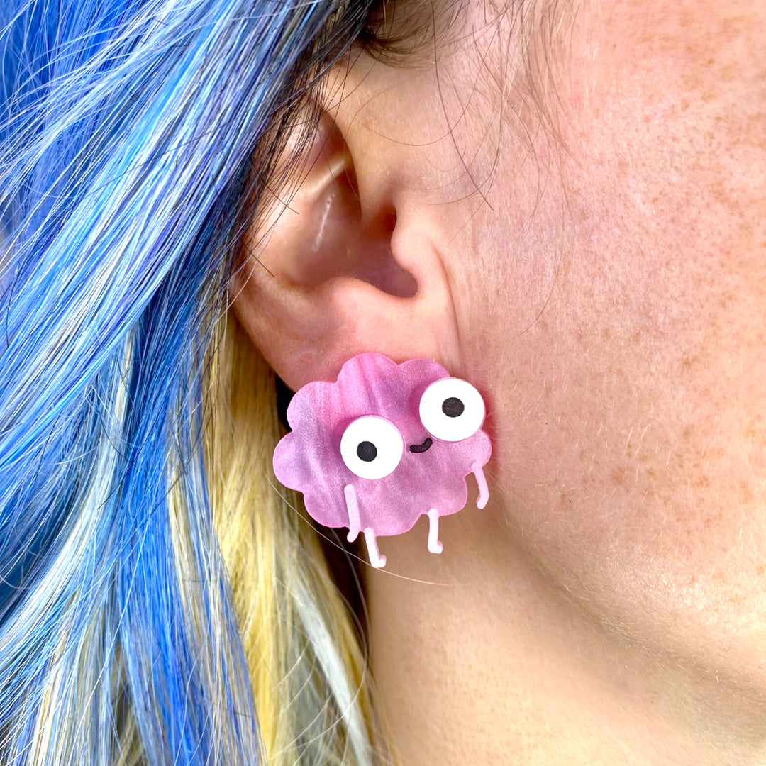 Our handmade Sarah's Scribbles Happy Brain stud Earring is worn by a woman with bright blue hair. 