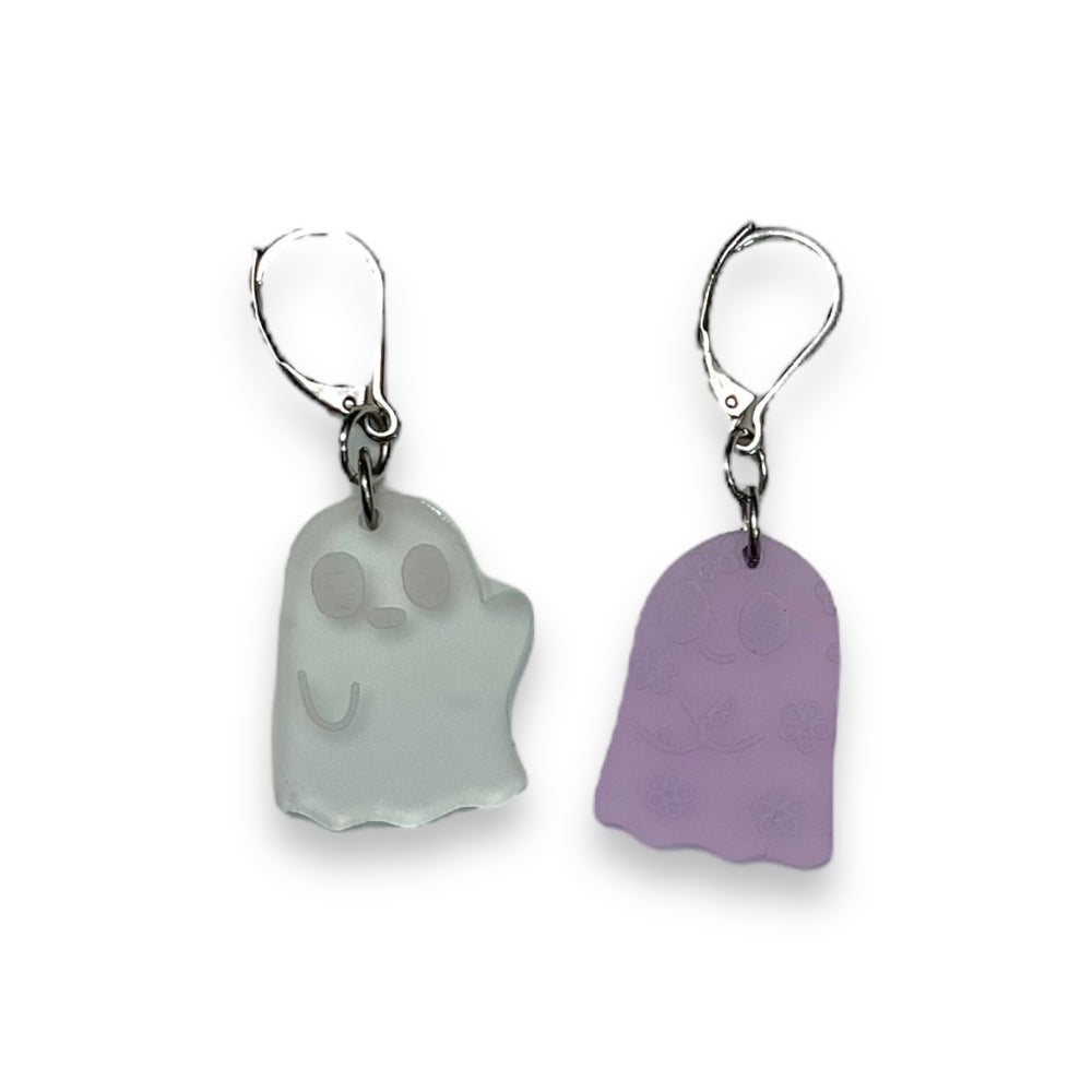 Sarah's Scribbles Cryptid Club dangle earrings are handmade and cut from frosted clear and lavender plastic. We use stainless steel findings for these pastel goth beauties!