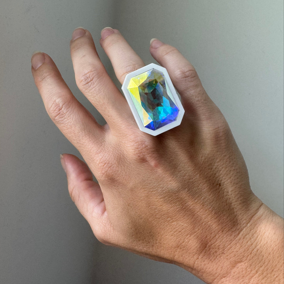 Extra large Sorceress Ring in white is shown worn on the ring finger.