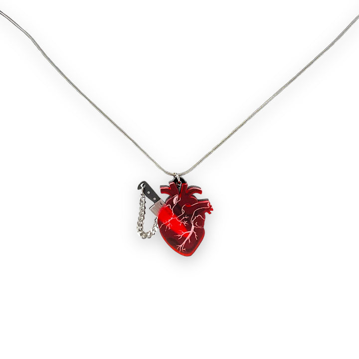 Anatomical heart necklace with a removable knife. 