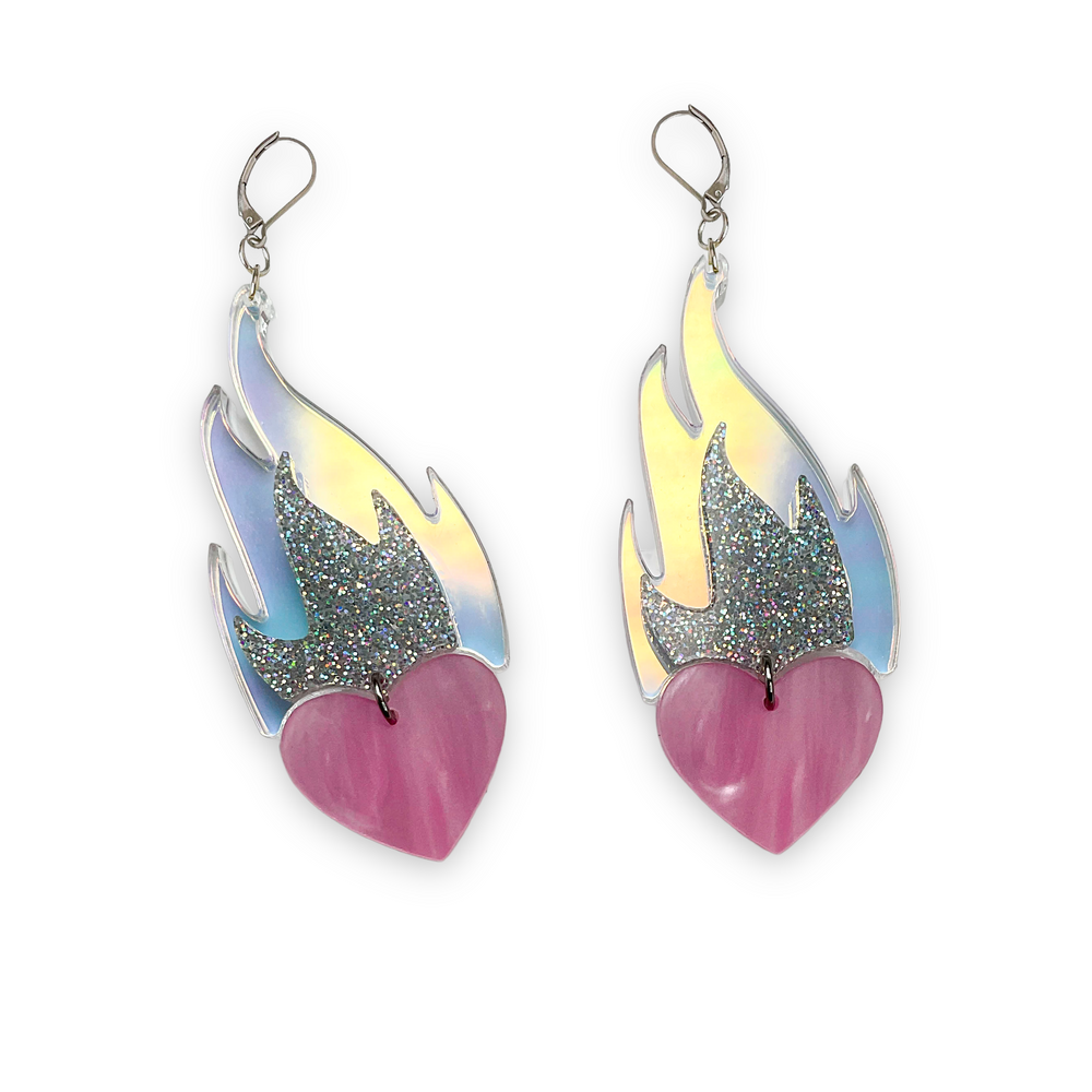 Vinca's Love A La Flambé earrings in pearl pink, glitter hologram and iridescent float on a white background.