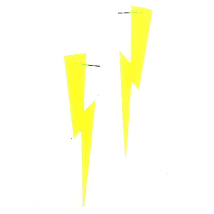 Handmade transparent green lightning bolt earrings floating on a white background.