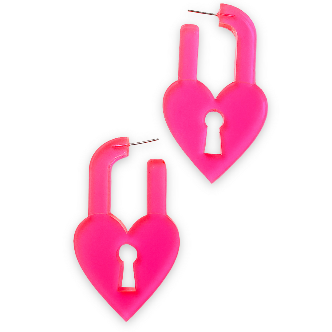 Our Heart Lock earrings are made from transparent neon pink plastic with a sturdy stainless steel post and  sit on a white background.