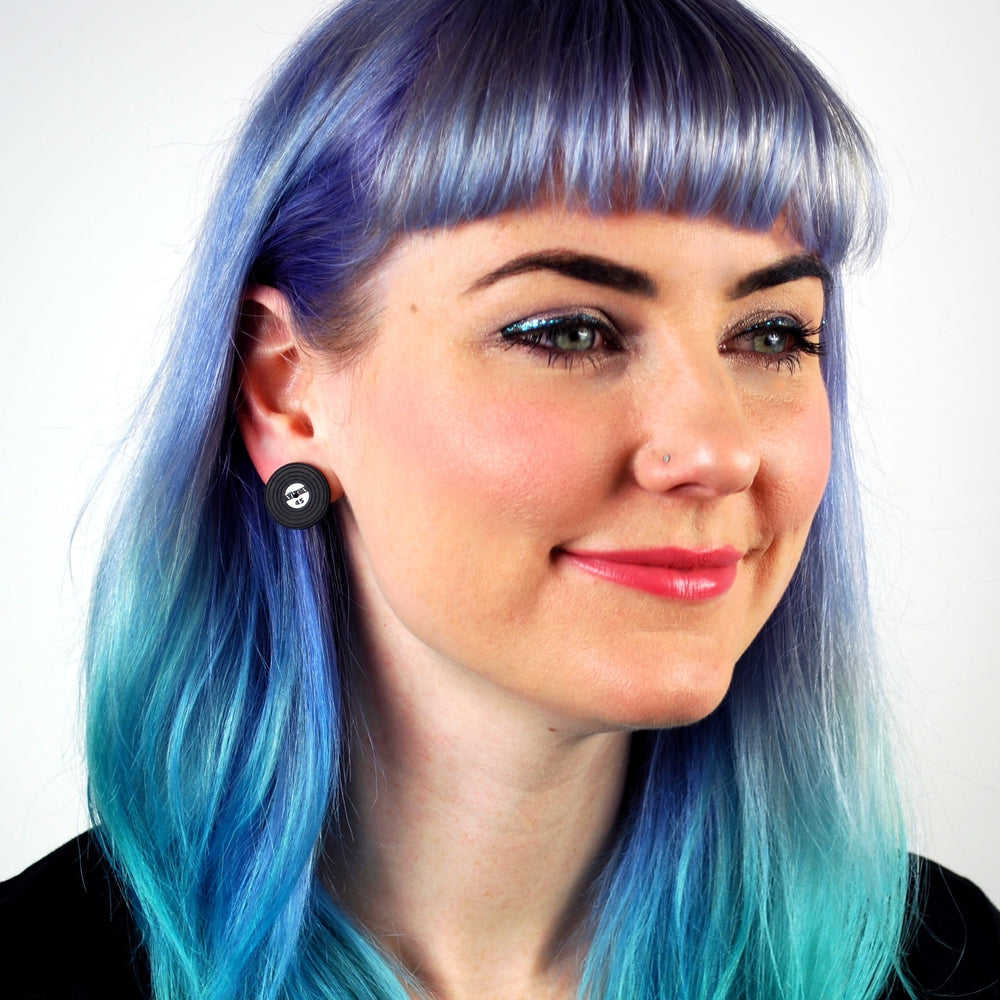 model with colorful hair wears miniature vinyl record earrings