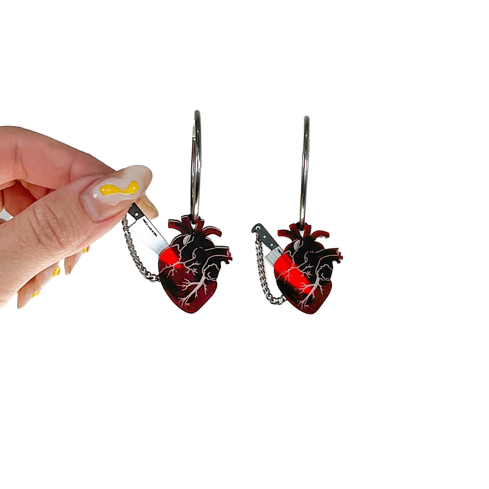 Edgy anatomical heart earrings with plastic knife in frosted red and silver. 