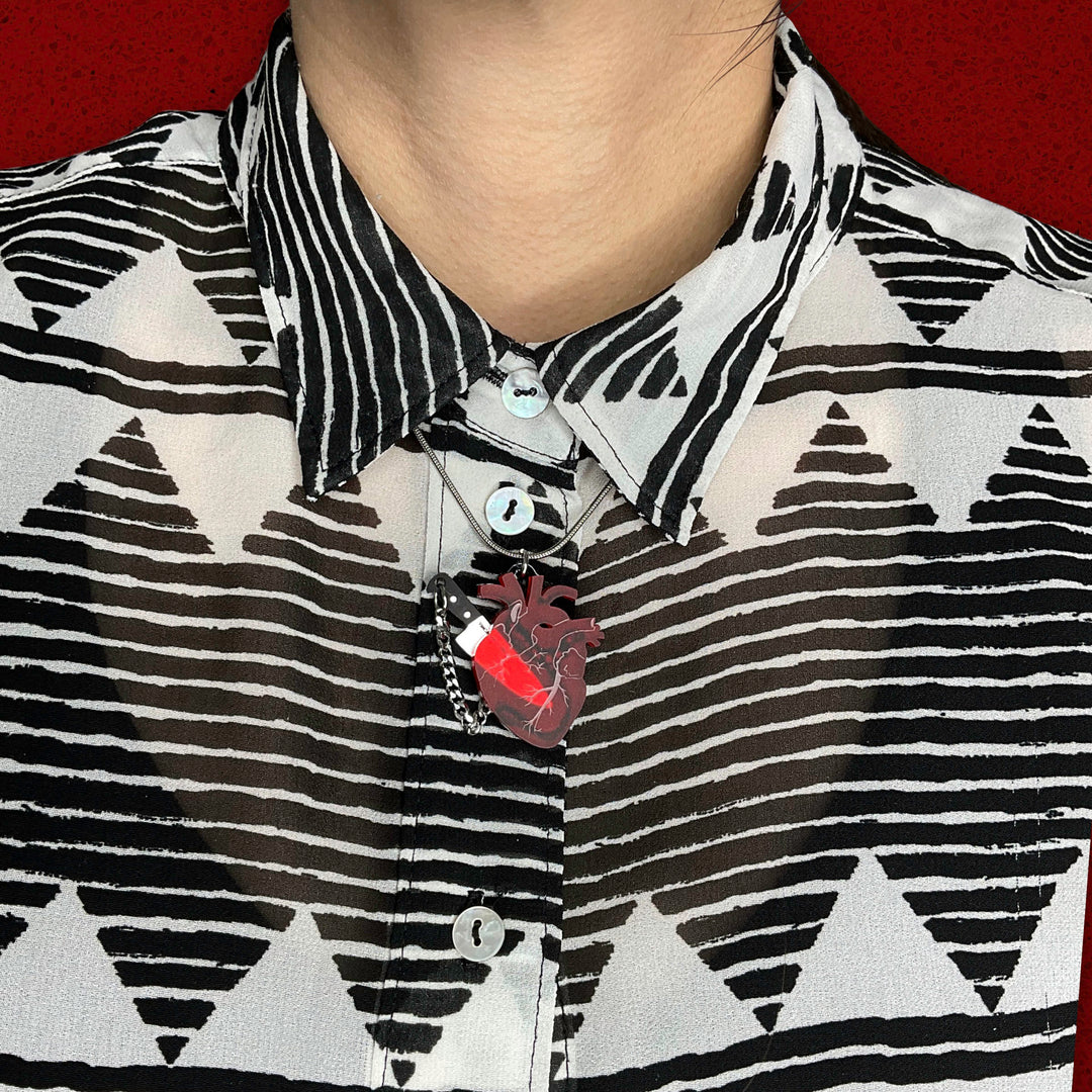 Collared shirt with our transparent frosted red anatomical heart necklace with tiny removable plastic knife.