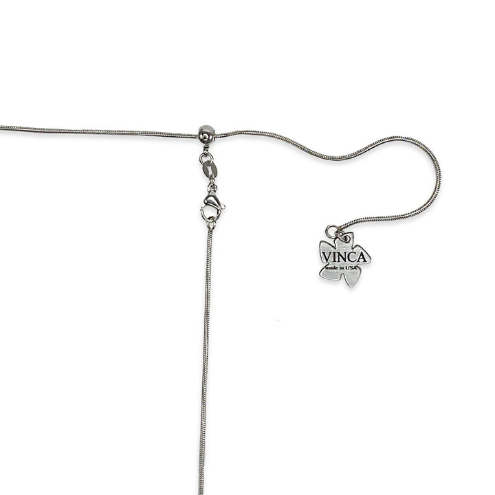 A closeup shot of our stainless steel snake chain with our Vinca branded hangtag.